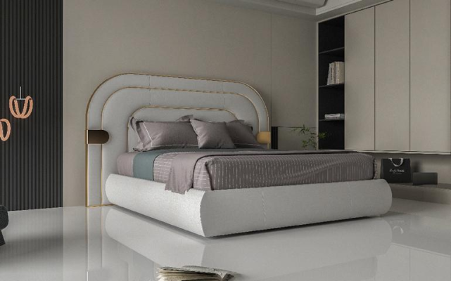 Lit gris luxueux avec des détails dorés dans un design moderne et une tête de lit rembourrée