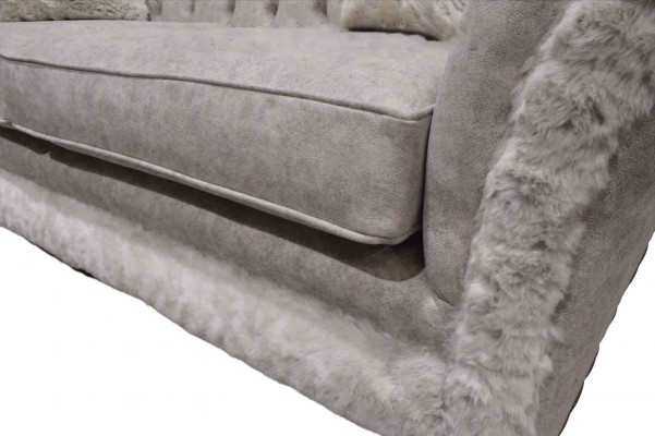 Moderne canapé design trois places en tissu d'ameublement beige Chesterfield pour le salon.