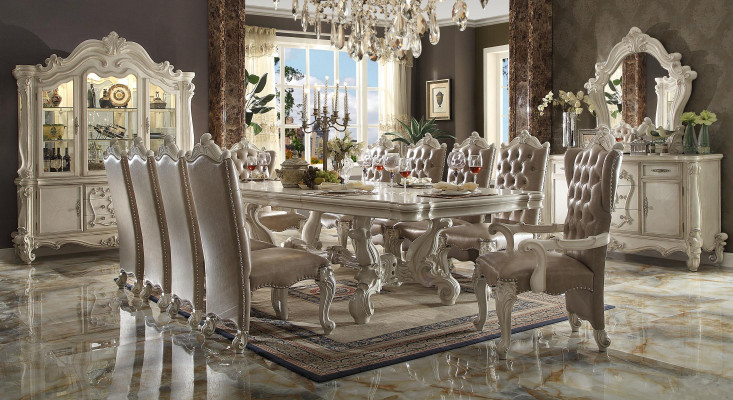 Ensemble de salle à manger classique en blanc antique. Grande table à manger avec des chaises Chesterfield.