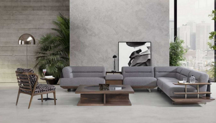 Ensemble de salon moderne avec canapé d'angle en L, fauteuil et table basse au design luxueux.