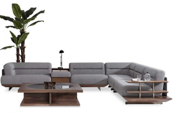 Ensemble de salon moderne avec canapé d'angle en L, fauteuil et table basse au design luxueux.