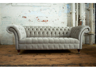 Élégant canapé Chesterfield gris clair trois places de luxe pour le salon.