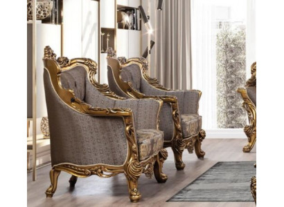 Un fauteuil à oreilles classique luxueux en gris foncé avec un design baroque doré de style Chesterfield