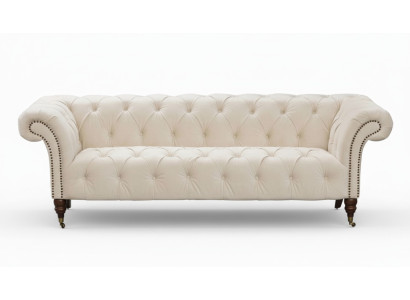Canapé beige design moderne trois places Chesterfield en tissu.