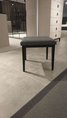 Confortable et élégant tabouret moderne en textile pour chambre.