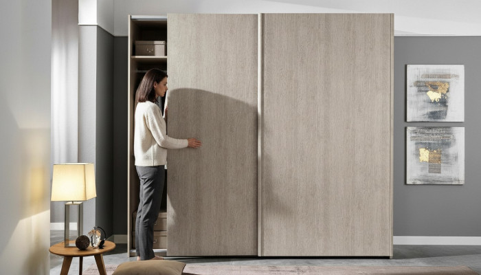 Garde-robe moderne avec des portes coulissantes pour la chambre à coucher en bois naturel.