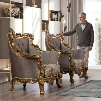 Un fauteuil à oreilles classique luxueux en gris foncé avec un design baroque doré de style Chesterfield