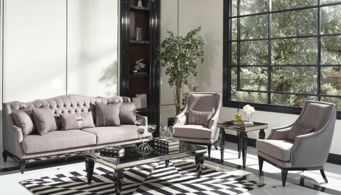 Ensemble de canapé 3 places en tissu gris comprenant un canapé et 3 fauteuils.