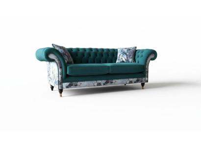 Un canapé Chesterfield trois places vibrant dans une délicate couleur émeraude avec un motif floral.