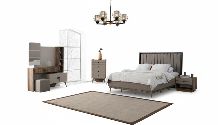 Suite de chambre grise avec lit double, 2 tables de chevet en bois et une coiffeuse.
