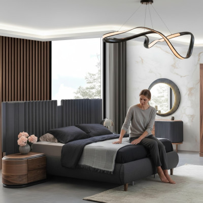 Suite de chambre moderne en gris avec lit en textile et tables de chevet en bois, commode.