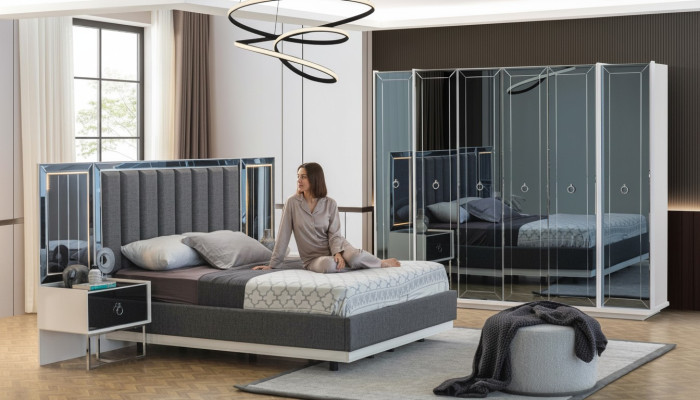 Ensemble de chambre à coucher design avec lit double, table de chevet et armoire.